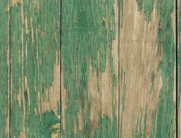 Weathered planks set in vertical fashion with scratches and fading paint.